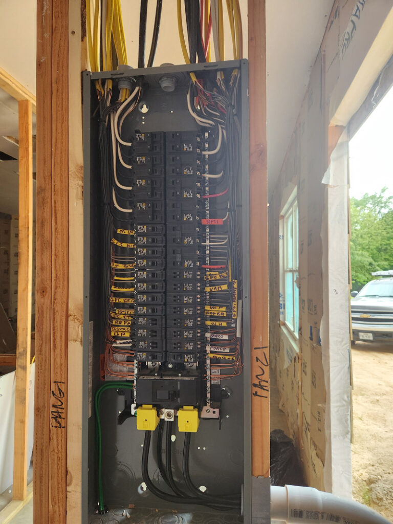 electrical panel in installed in the garage of a new construction job